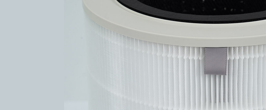 Top view of a replacement pleated filter cartridge showing the plastic cap and grey pull tab