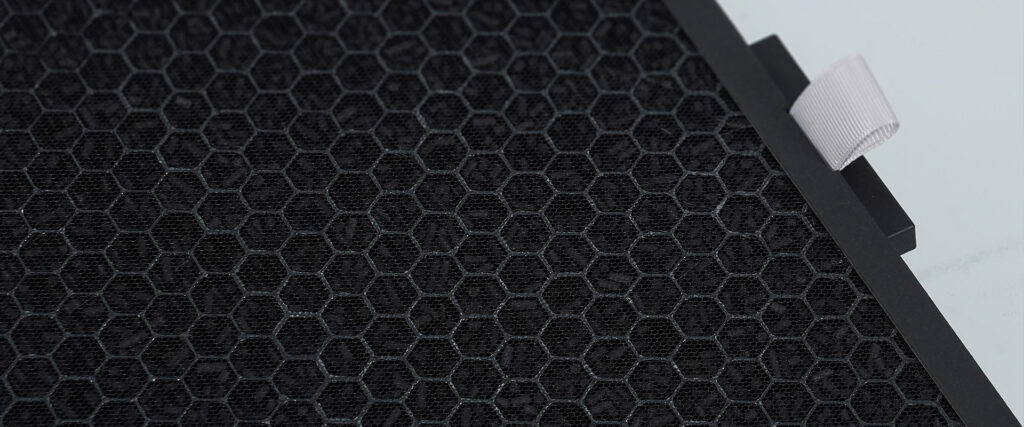 Close-up detail of honeycomb activated carbon filter mesh featuring a pull tab for easy removal